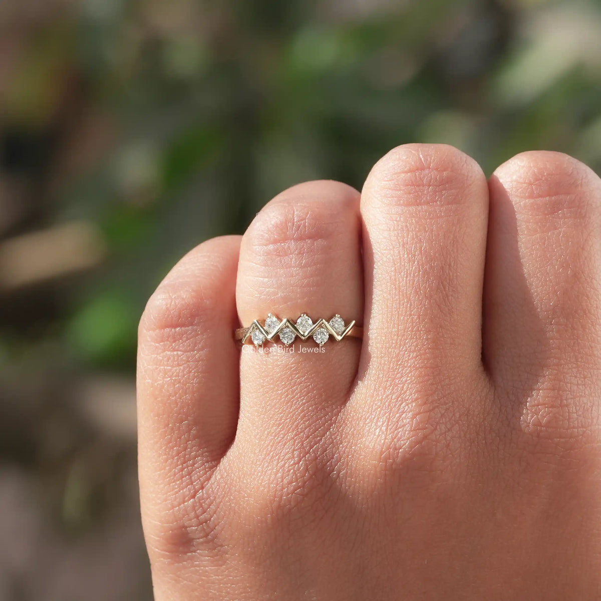 Silver-tone eternity band ring featuring five round prong-set stones on a slim band