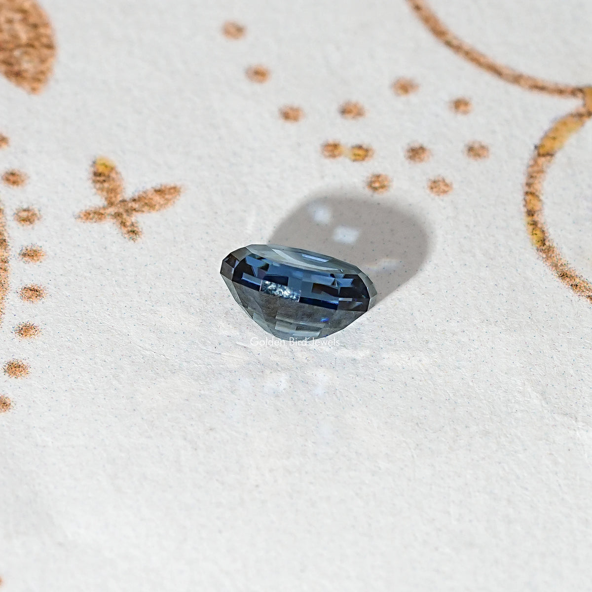 Loose step-cut oval blue moissanite gemstone with crisp geometric facets