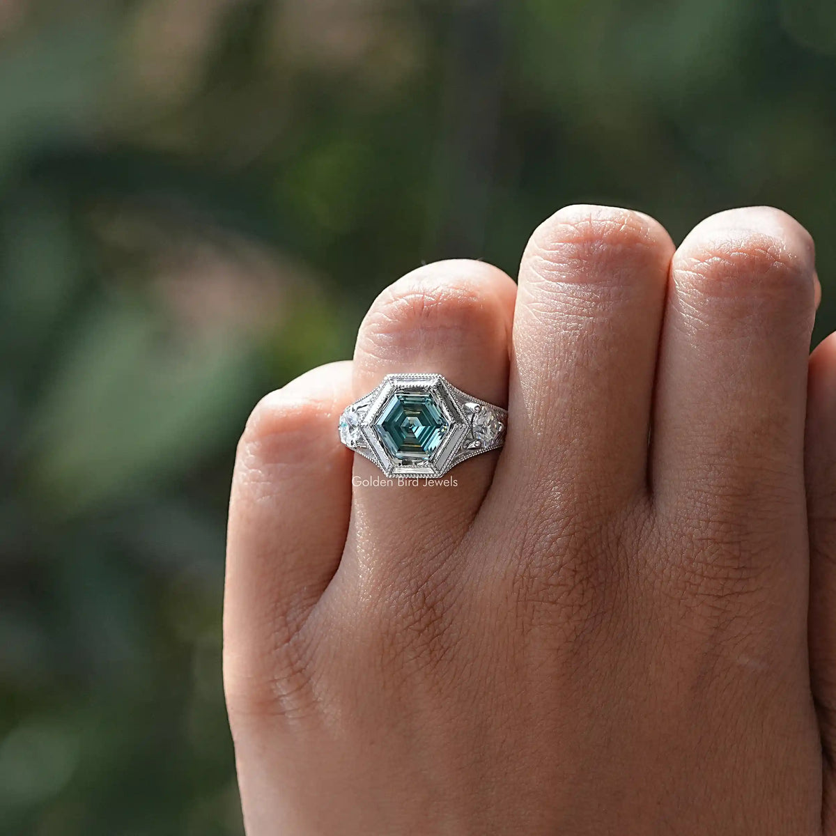 925 sterling silver three-stone ring with teal hexagon moissanite center and small side stones