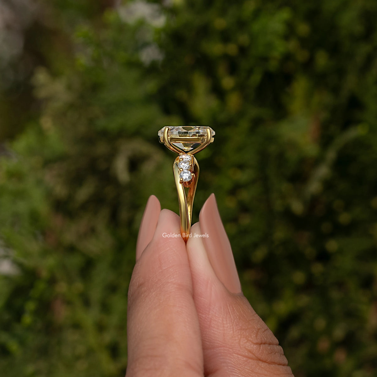 Gold-tone infinity ring with oval old mine center stone and round halo accents