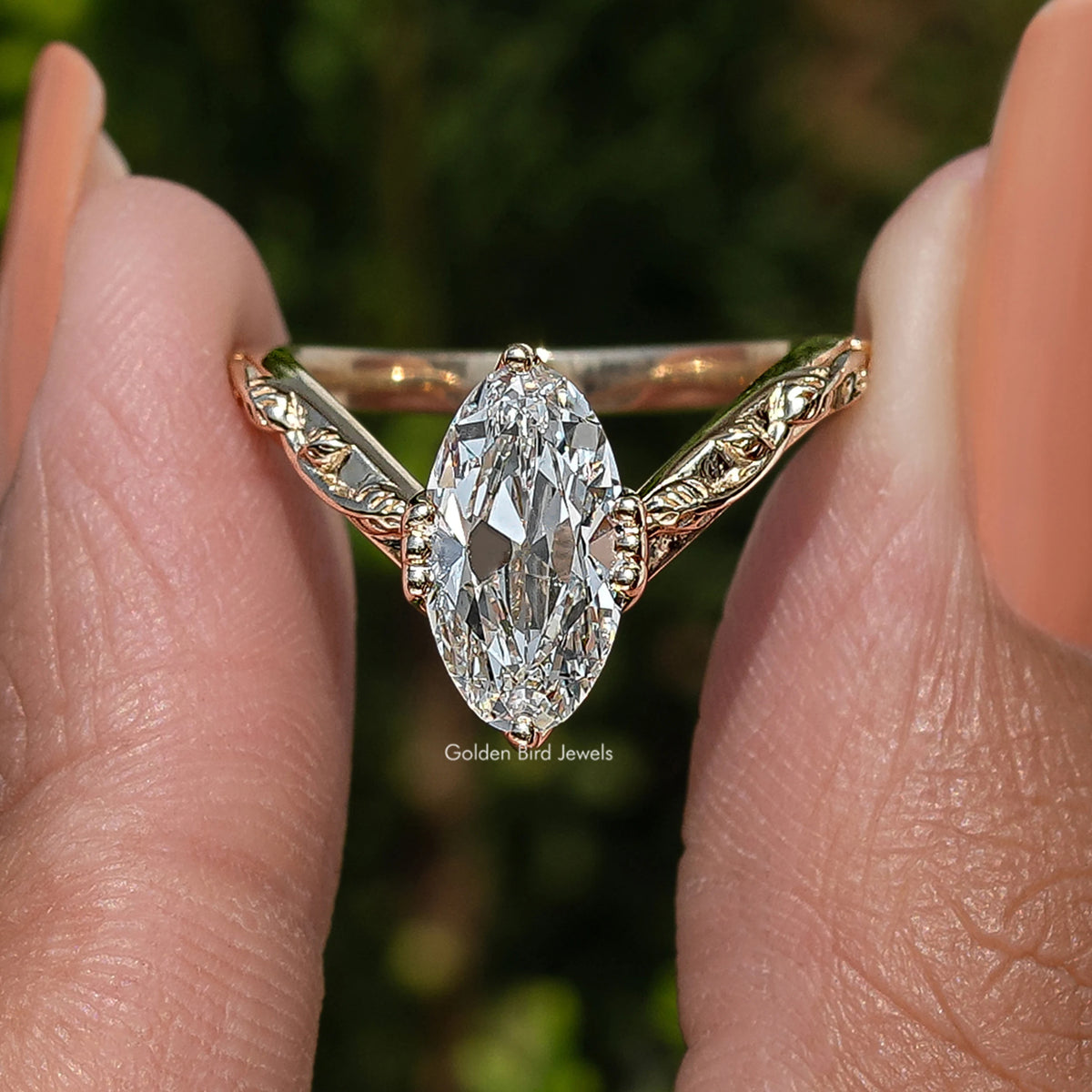 Curved diamond ring with large oval center stone and gold-tone side prongs