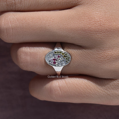 Silver-tone oval floral signet ring with purple-pink gemstones and decorative border