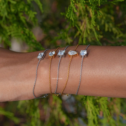 Stacked bracelets with silver and gold-tone chains and square/round moissanite