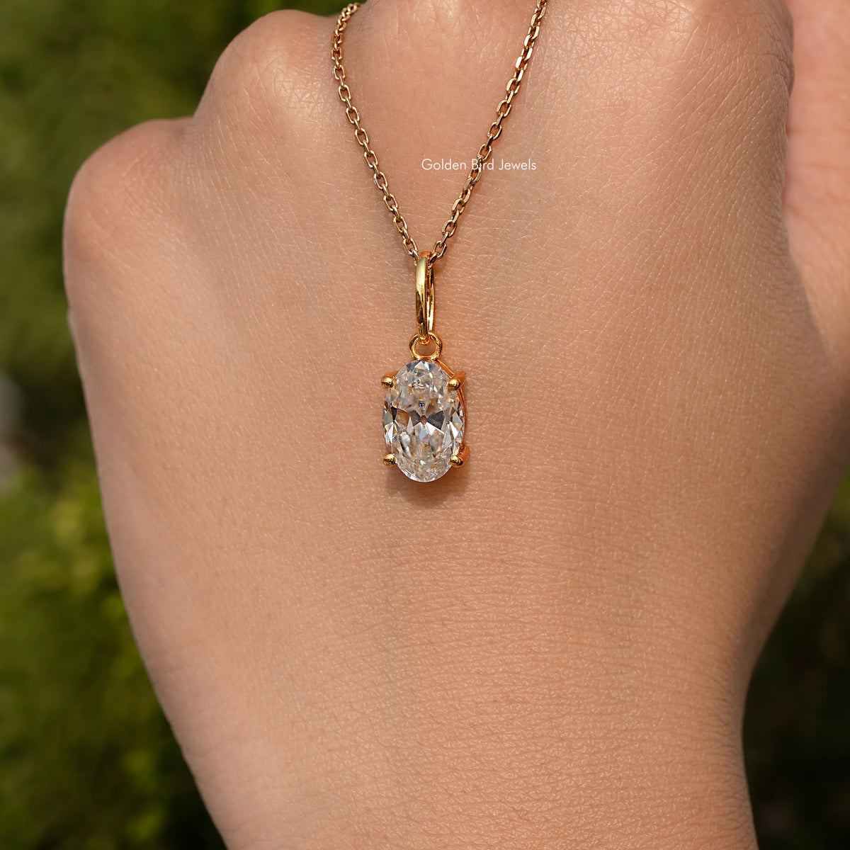 In hand Showing View Of Old Mine Oval Moissanite Pendant 