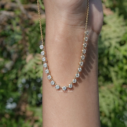 Gold-tone round-cut moissanite tennis necklace with repeating stones along chain