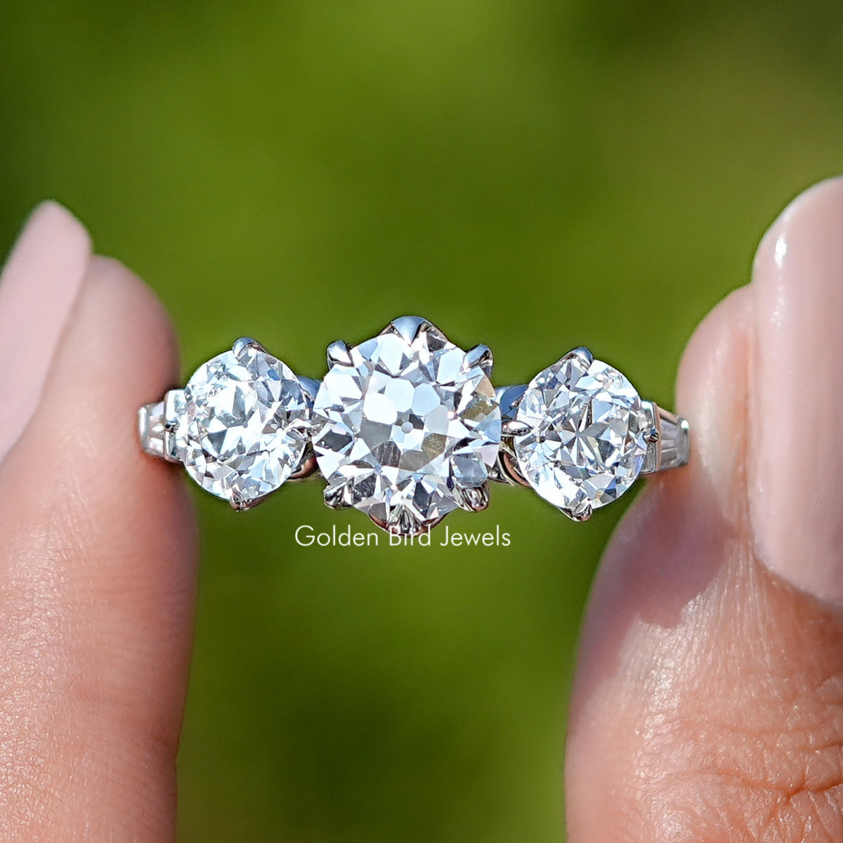 Old European Round Cut Lab Diamond Five Stone Ring held between fingers 