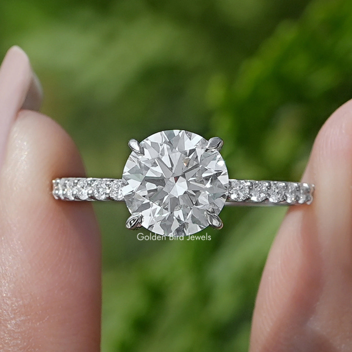 Round Cut Lab Diamond Solitaire Ring Held Between Fingers