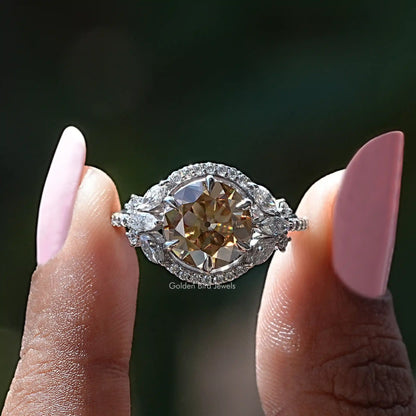 Silver halo cluster ring with large round champagne center stone and side stones