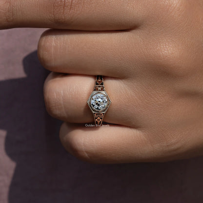 Close-up of round diamond center with engraved halo details on engagement ring