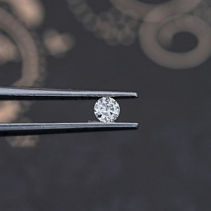 Single round lab-grown diamond held on metal tweezers
