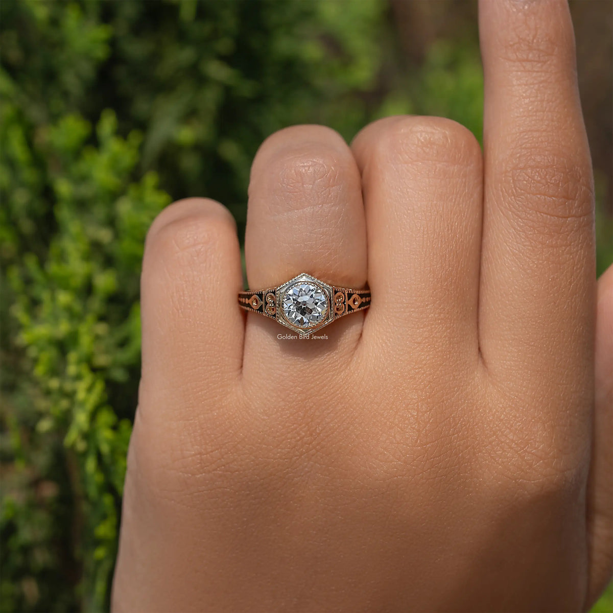 Ornate diamond engagement ring with round center stone and filigree side details