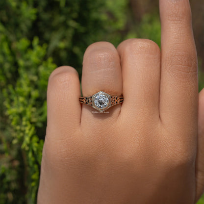 Ornate diamond engagement ring with round center stone and filigree side details