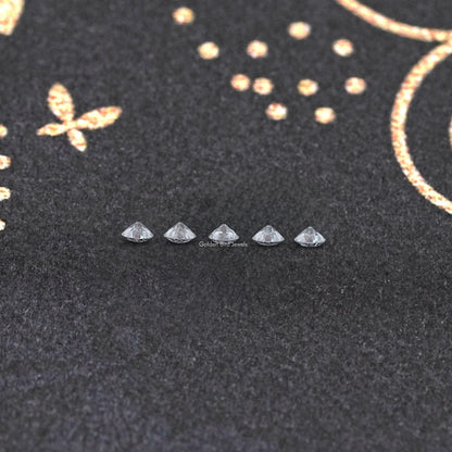 Round lab-grown diamonds shown as small faceted stones in a row