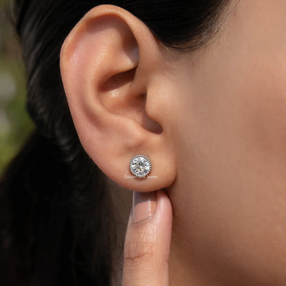 Round milgrain bezel stud earring on ear, clear round center stone, silver-tone