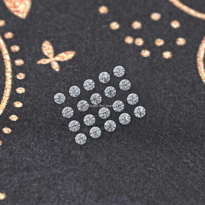 Round lab-grown diamond cluster, small clear stones on dark display