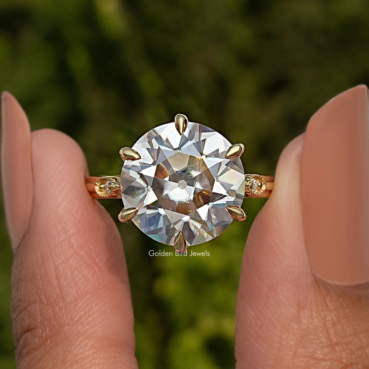 Round moissanite engagement ring with large center stone and prong-like shoulders