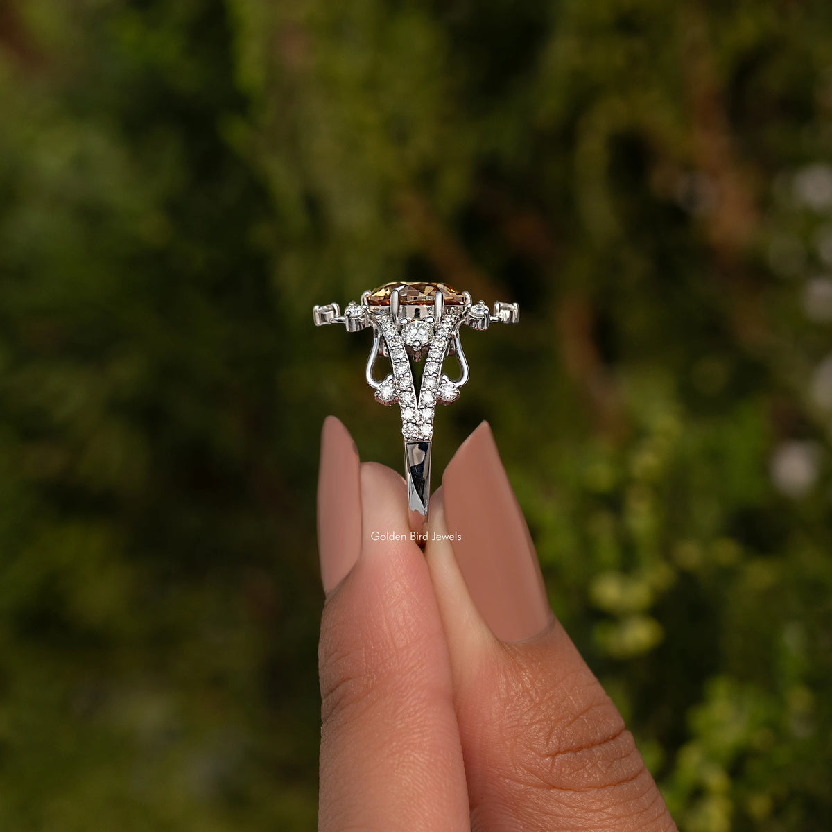 Silver round-cut moissanite ring with detailed halo and side prongs