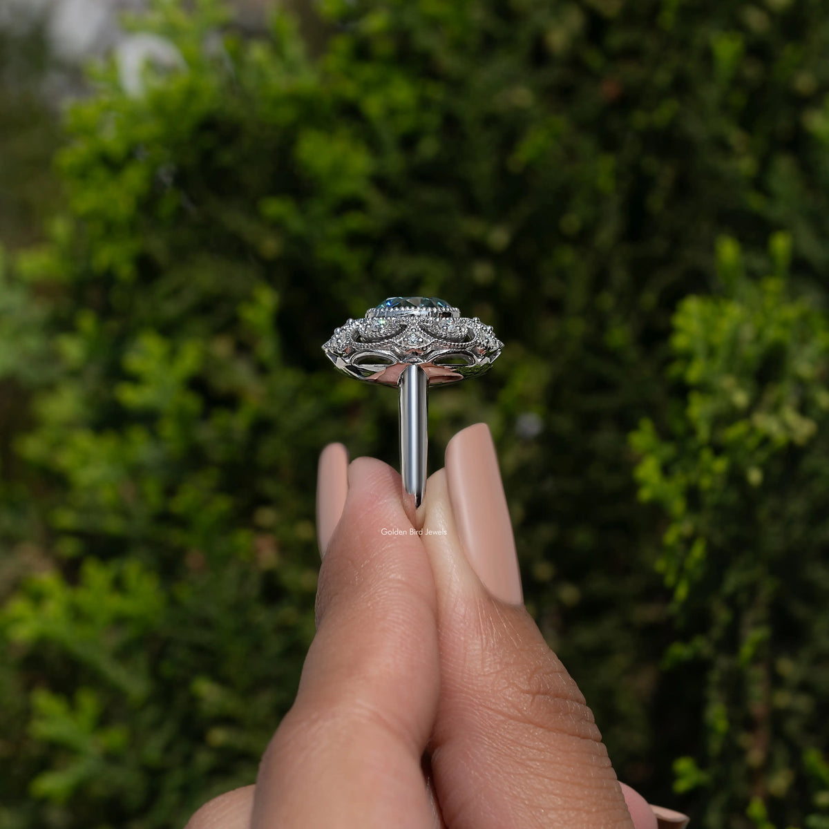 Round-cut blue moissanite ring with vintage silver prongs and filigree halo