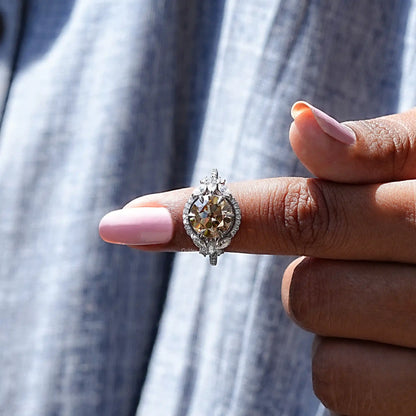 Silver halo cluster ring with round champagne center stone and side accents