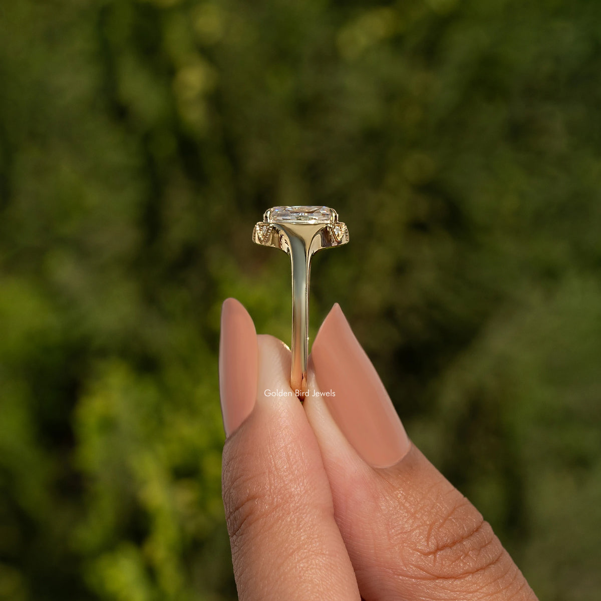 Elongated cushion-cut moissanite ring top view with gold-toned prong setting