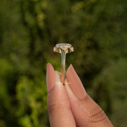 Elongated cushion-cut moissanite ring top view with gold-toned prong setting