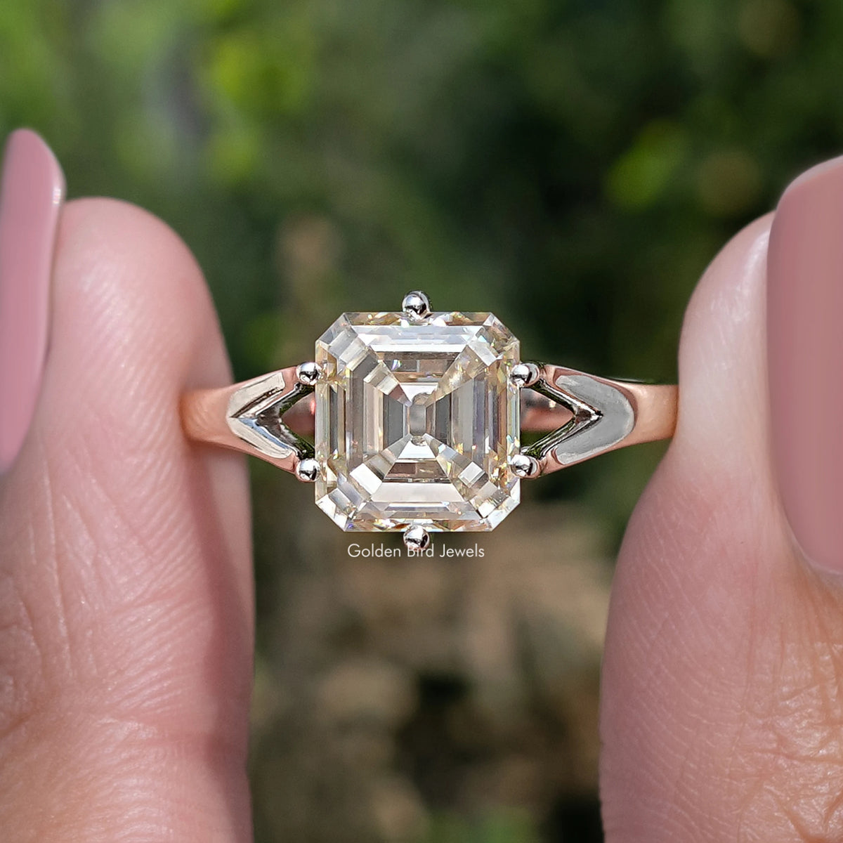 Yellow asscher-cut moissanite ring close-up with split shoulders and four-prong setting