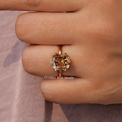 Gold tone solitaire ring with cushion-cut gemstone and four-prong setting