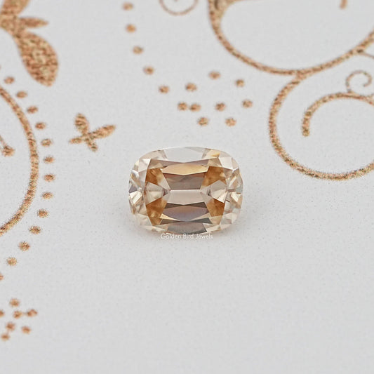 Golden yellow cushion-cut loose gemstone with faceted oval shape