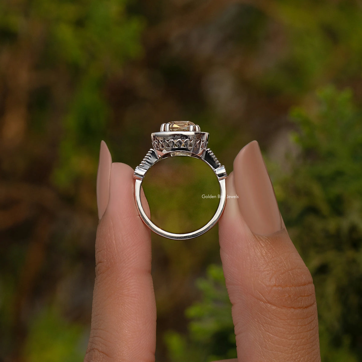 Sterling silver side view of halo cushion ring with prong-set center stone