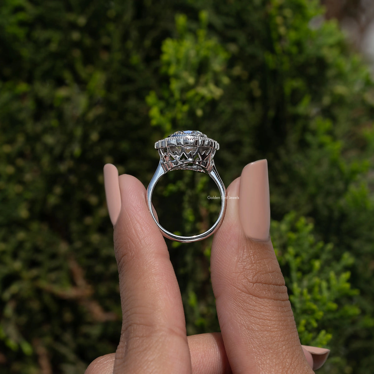 Sterling silver halo ring underside view, cushion-cut center with pink accents