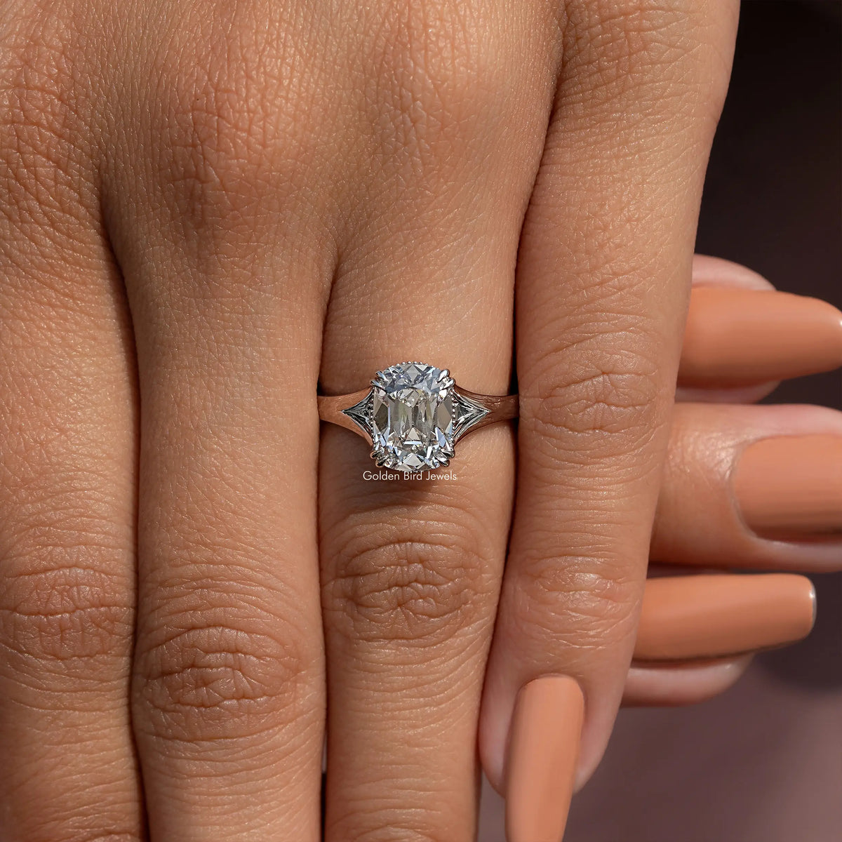 Cushion-cut diamond split-shank ring centered on finger, three-quarter view
