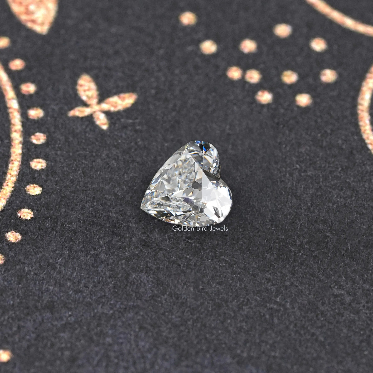 Loose heart-cut diamond, clear brilliant facets on dark display
