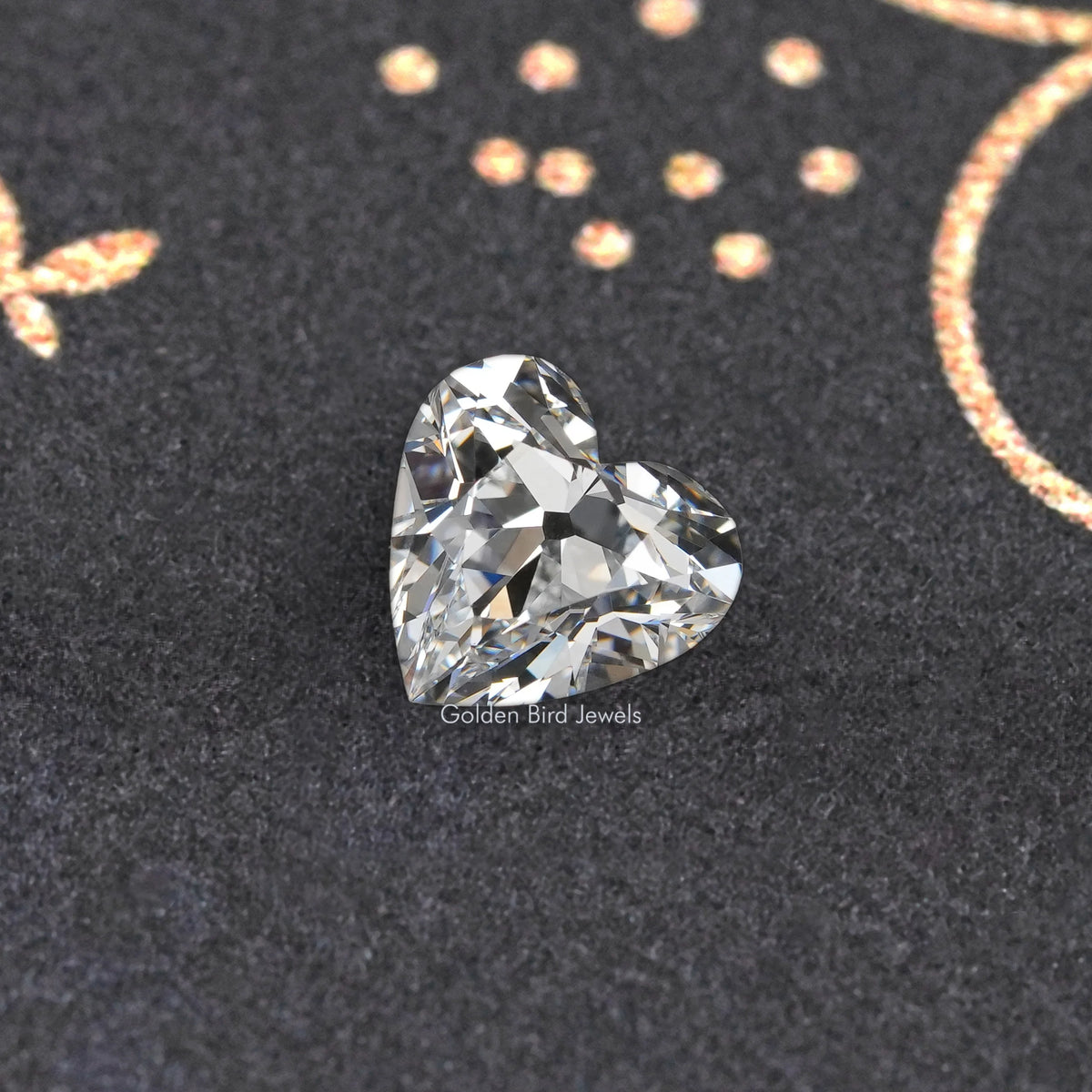 Loose heart-cut diamond with crisp brilliant facets on dark velvet