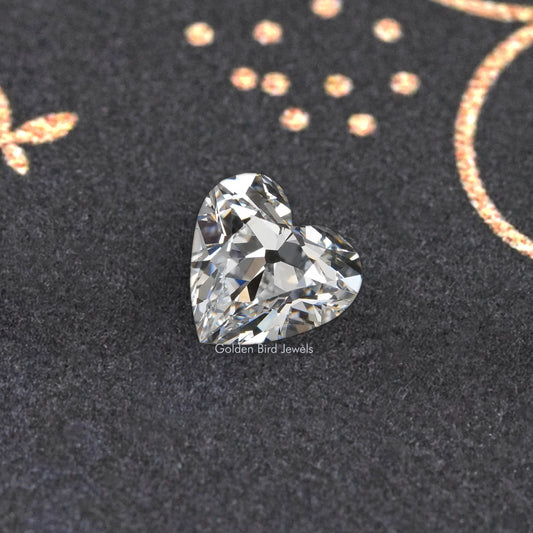 Loose heart-cut diamond with crisp brilliant facets on dark velvet
