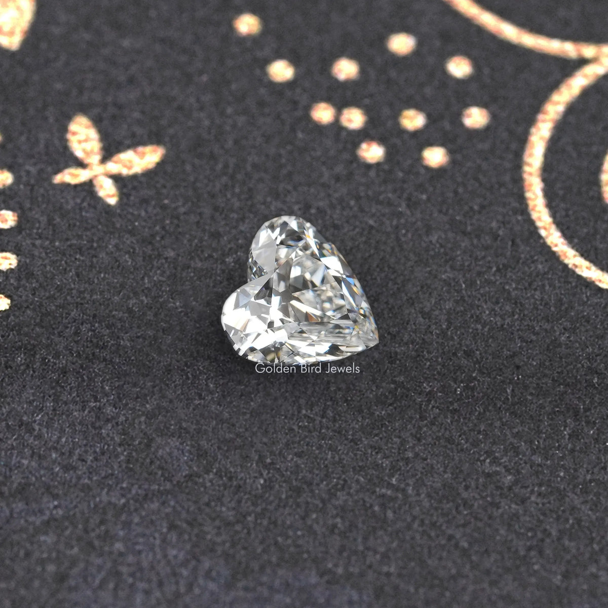 Loose heart-cut diamond with sparkling facets on dark jewelry backing