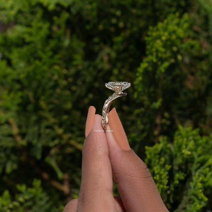 Curved diamond ring with ornate prongs, top view on fingertip