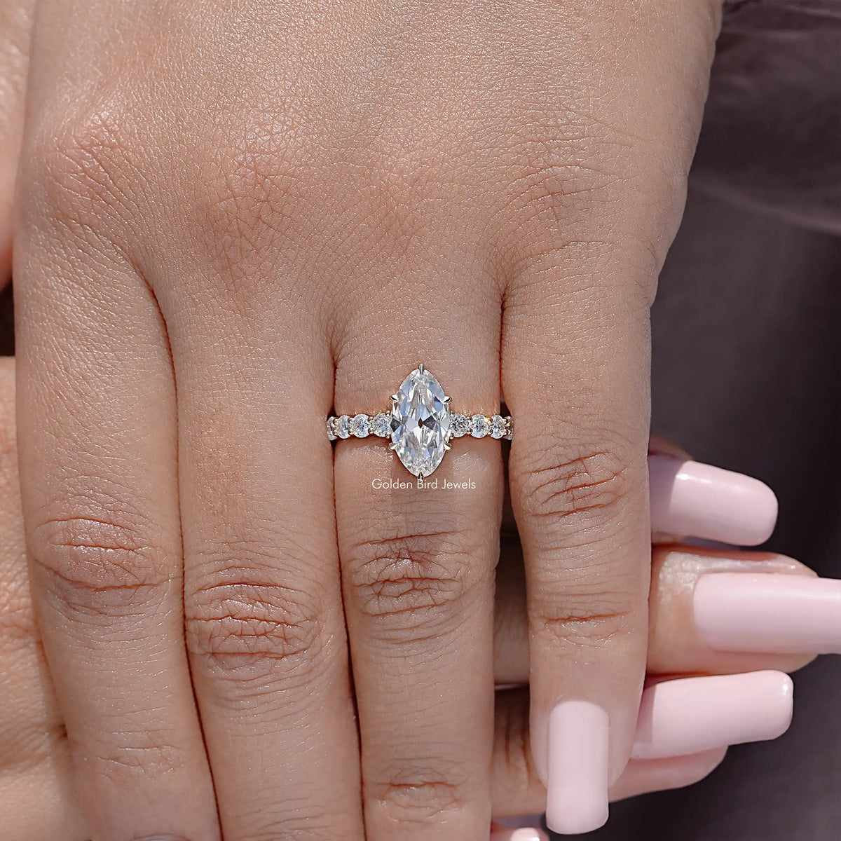 Moissanite ring with marquise center stone and round accent stones
