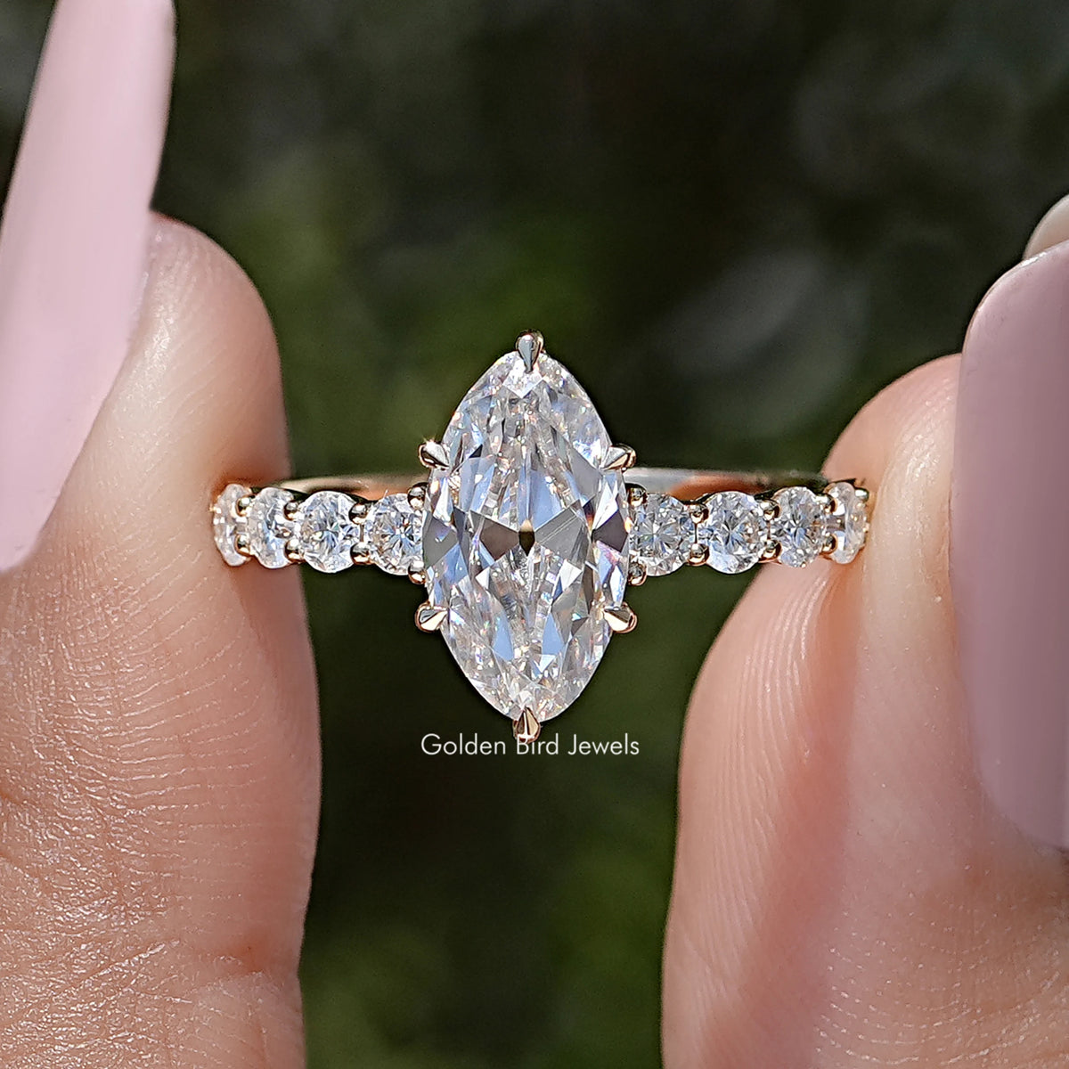 Silver-tone moissanite ring with oval center stone and round side stones on band