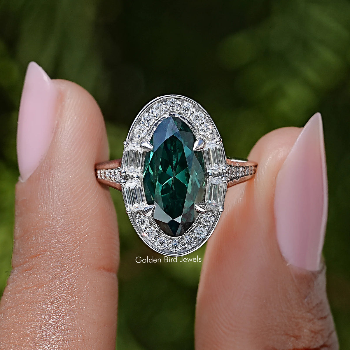 Halo ring with dark green oval center gemstone and sparkling silver side accents