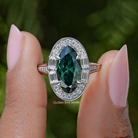 Halo ring with dark green oval center gemstone and sparkling silver side accents