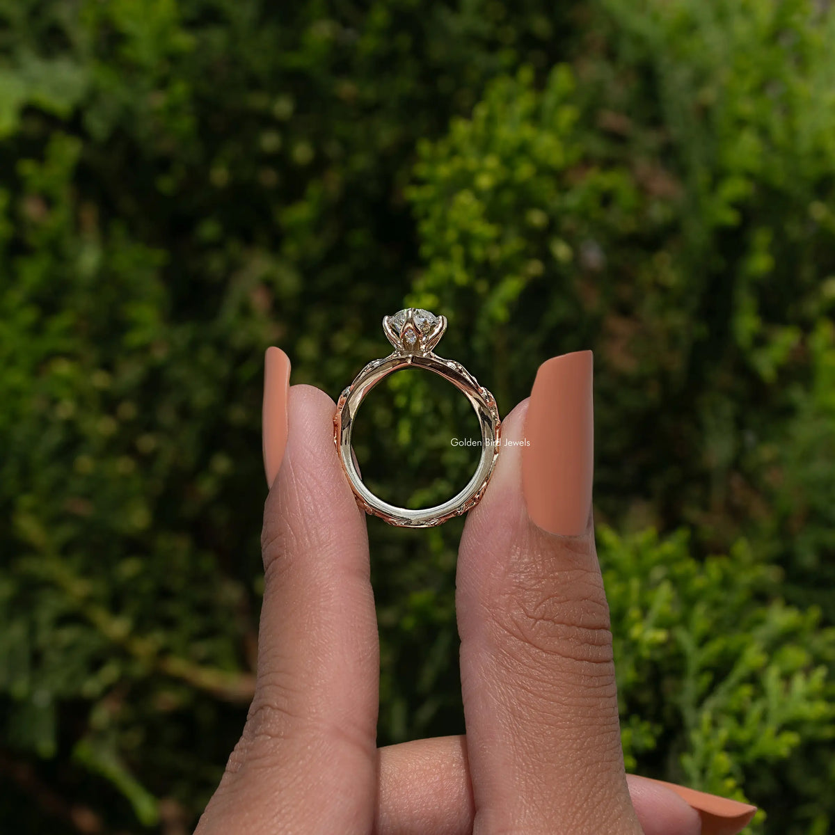 Gold-tone curved diamond ring showing open back with center stone