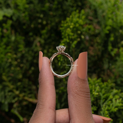 Gold-tone curved diamond ring showing open back with center stone