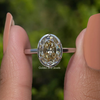 Oval moissanite solitaire ring with silver band, four-prong setting