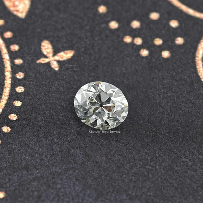 Oval-cut lab-grown diamond, old mine style, top view on dark surface