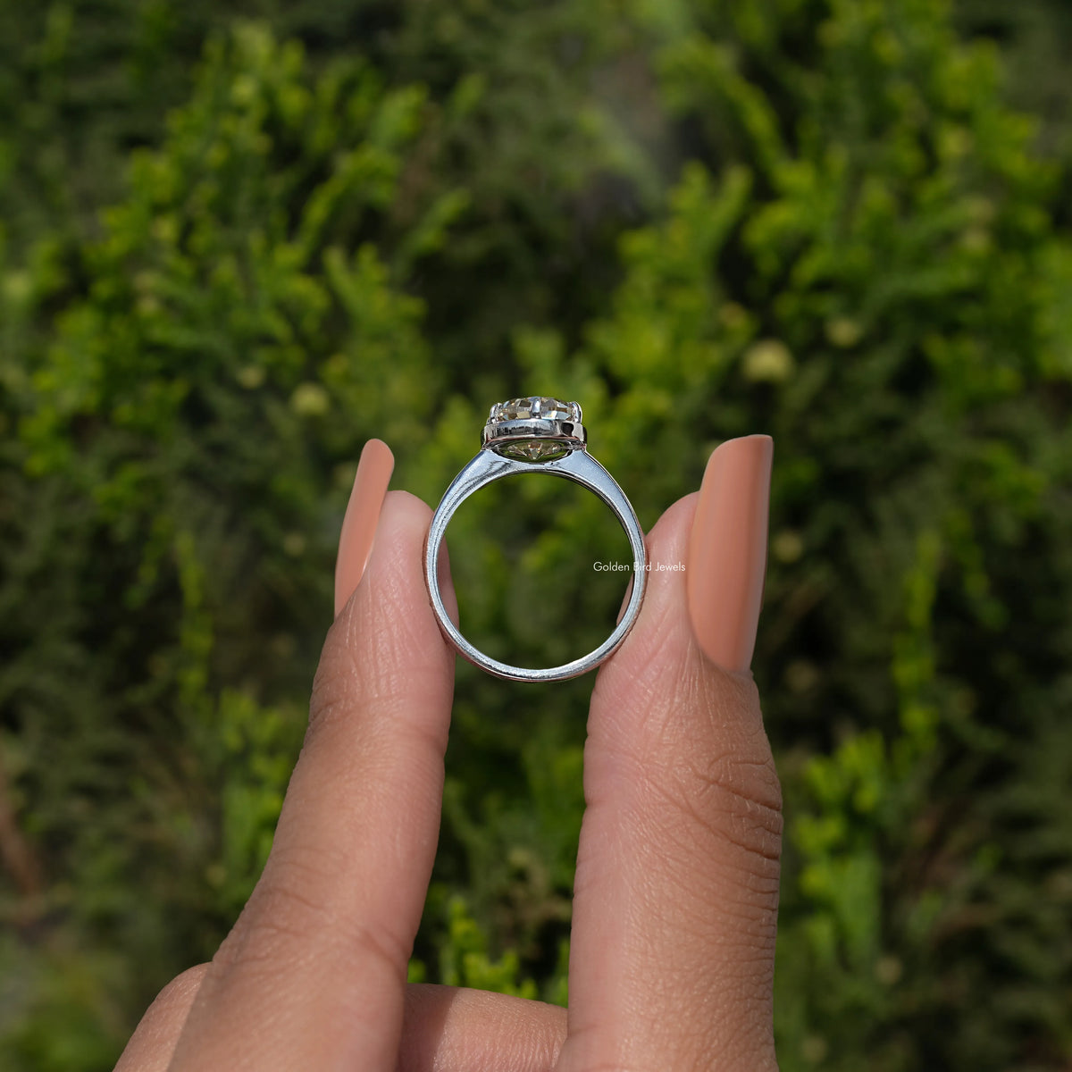 Silver oval moissanite solitaire ring, full view of band and prong setting