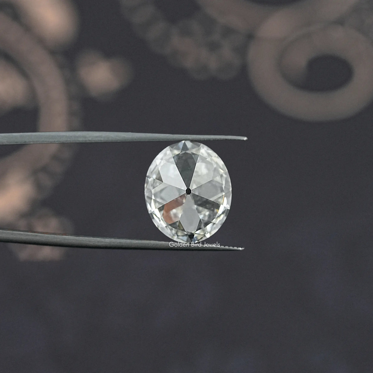 Oval-cut lab-grown diamond in tweezers, old mine style from front