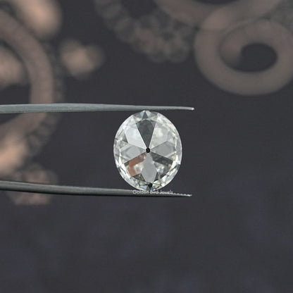 Oval-cut lab-grown diamond in tweezers, old mine style from front
