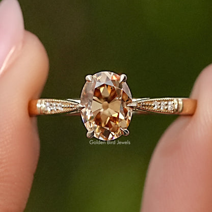 Oval moissanite solitaire engagement ring with pavé shoulders in yellow gold