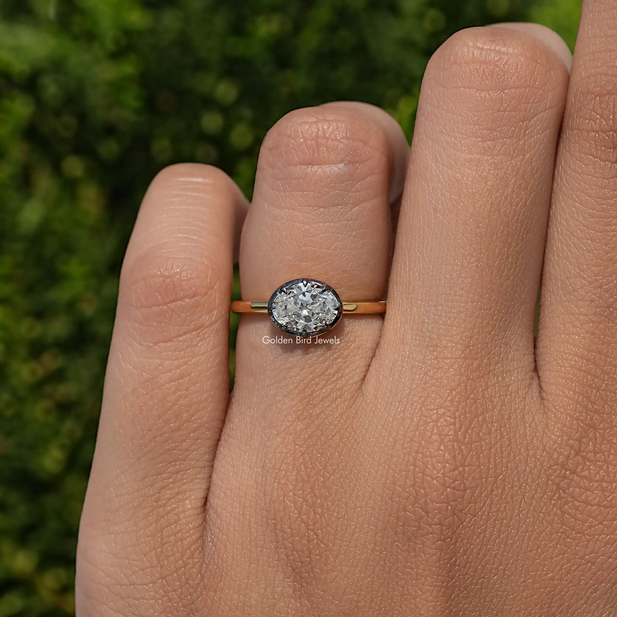 Gold oval-cut moissanite solitaire ring with oval center stone, close-up