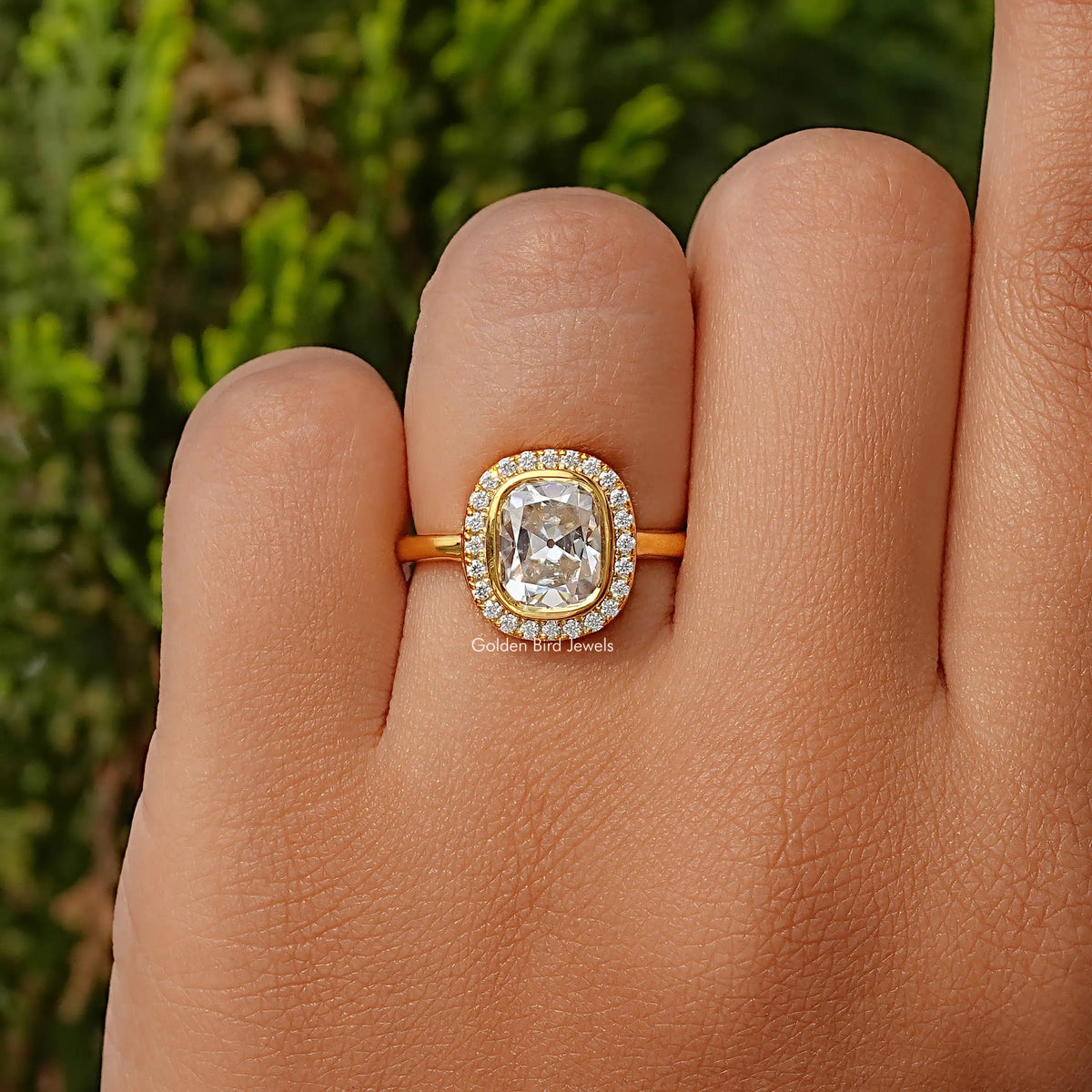 Cushion cut halo moissanite ring on finger